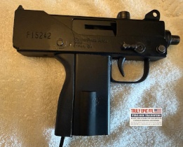 MasterPiece Arms Defender 9mm with faux suppressor, extended magazine, and original case.